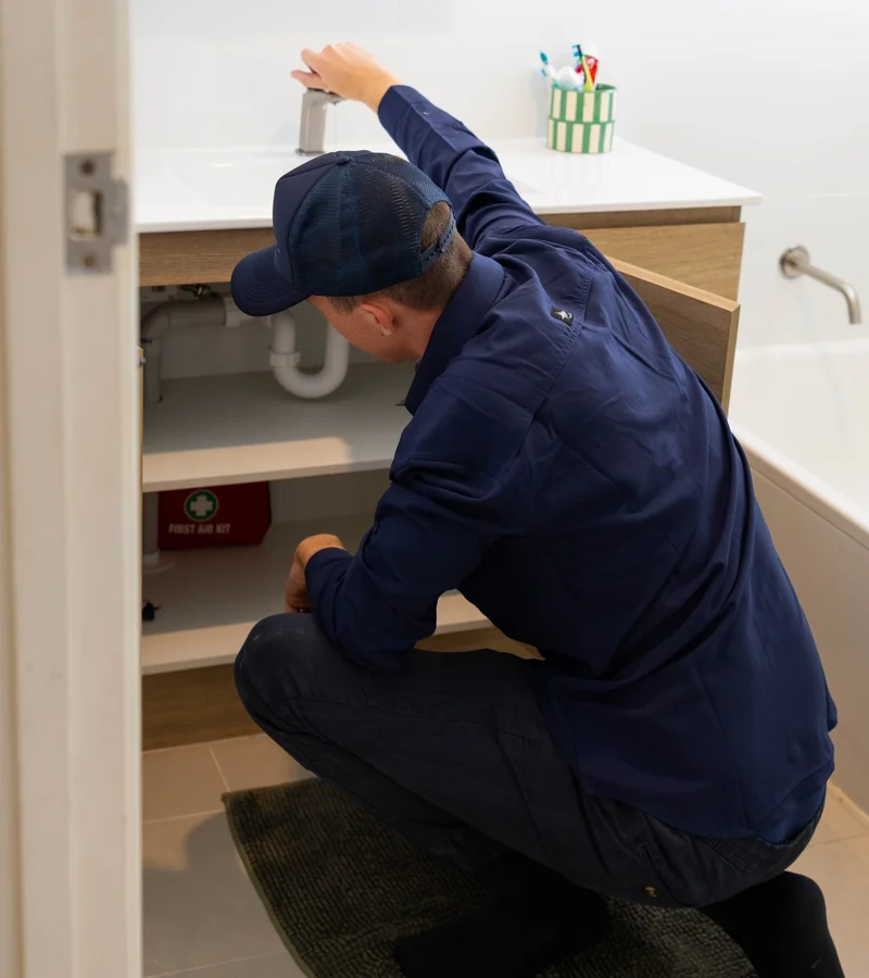 Plumber clearing a blocked drain with a hydro-jet